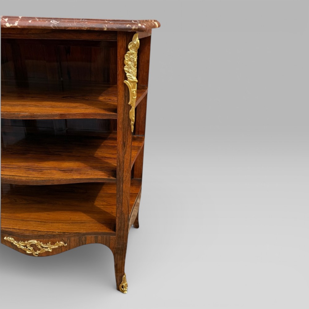 A French Louis XV style rosewood open side cabinet featuring a red marble top, three tiered shelves, and decorative brass ormolu mounts. View IV