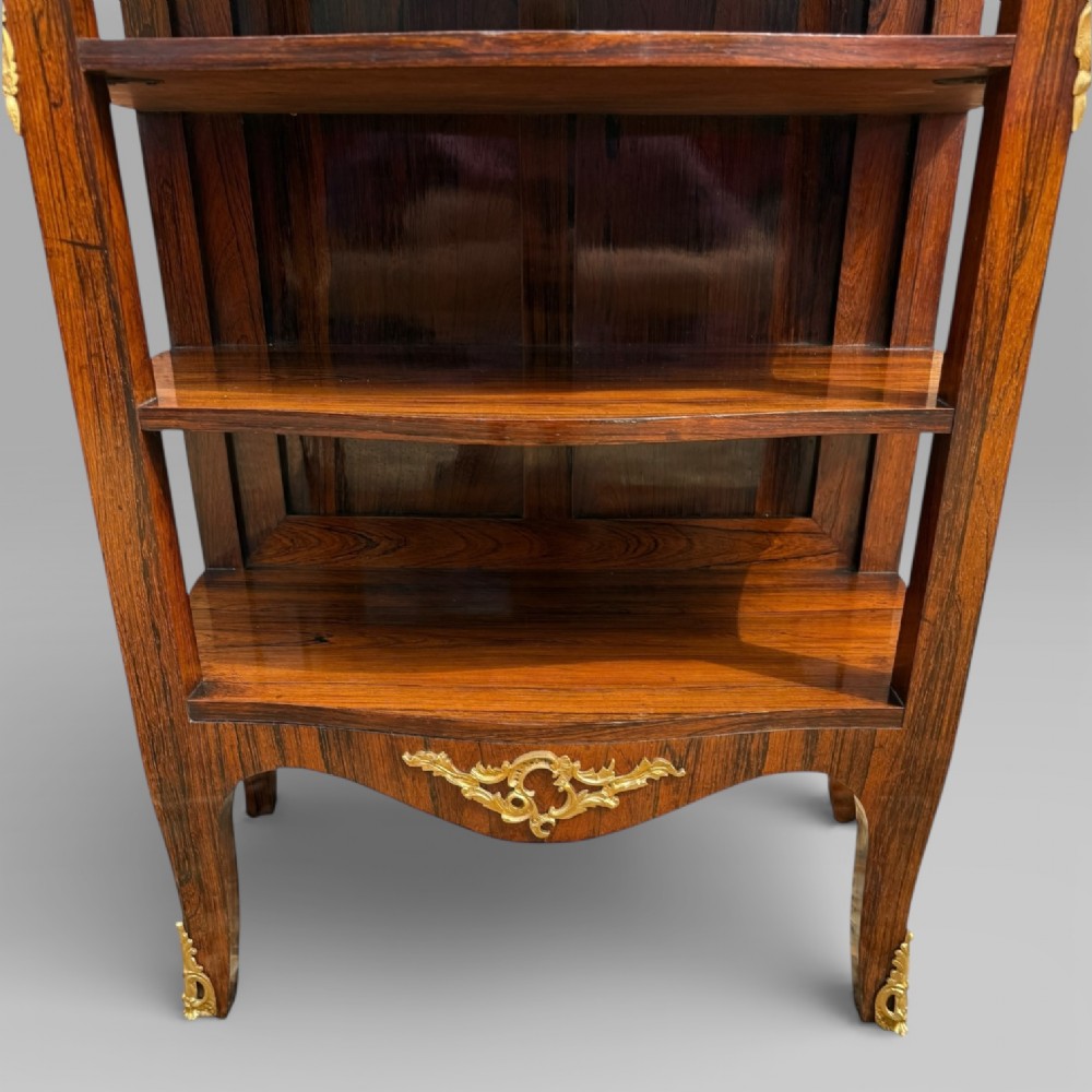 A French Louis XV style rosewood open side cabinet featuring a red marble top, three tiered shelves, and decorative brass ormolu mounts. View VII