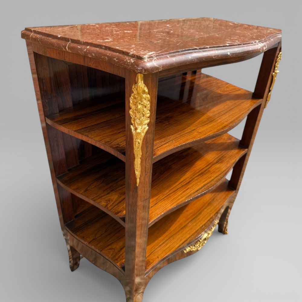 A French Louis XV style rosewood open side cabinet featuring a red marble top, three tiered shelves, and decorative brass ormolu mounts. View VIII