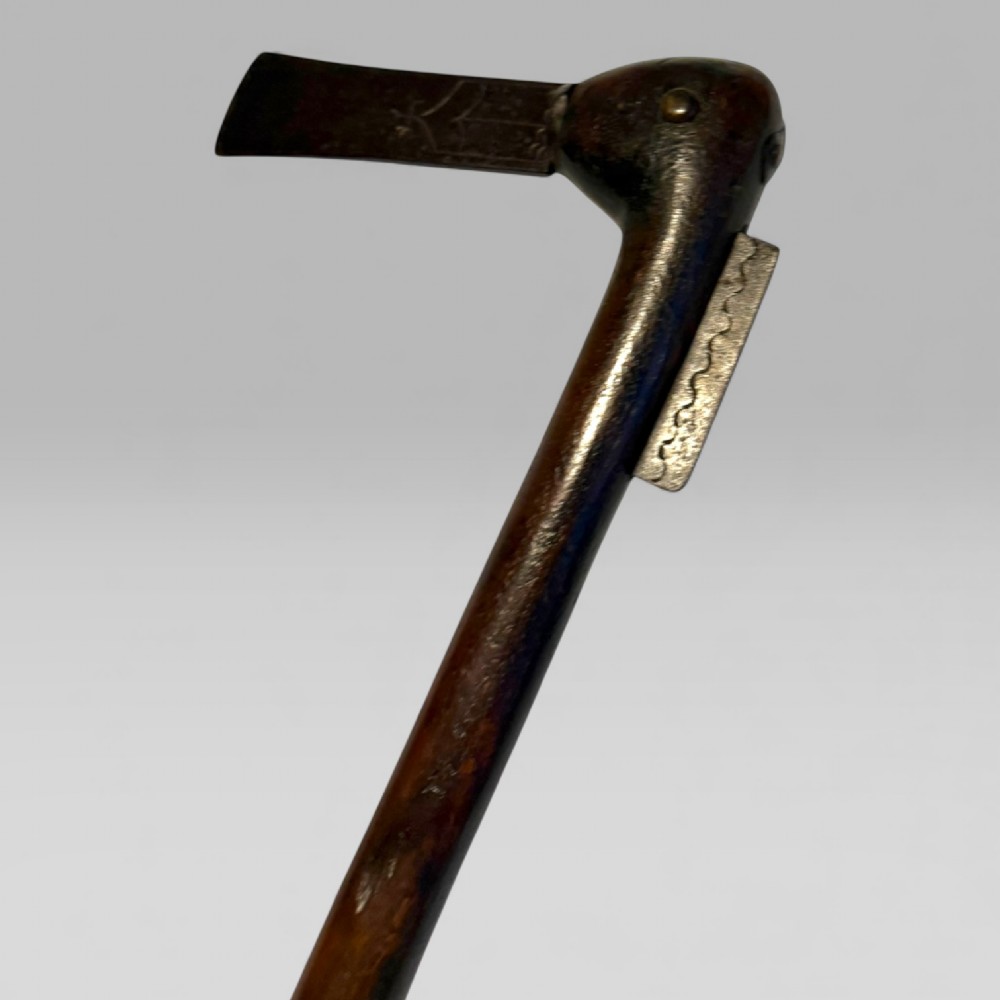 A 19th-century Dahomey messenger recade axe featuring an angled hardwood shaft and a flat iron blade. View II