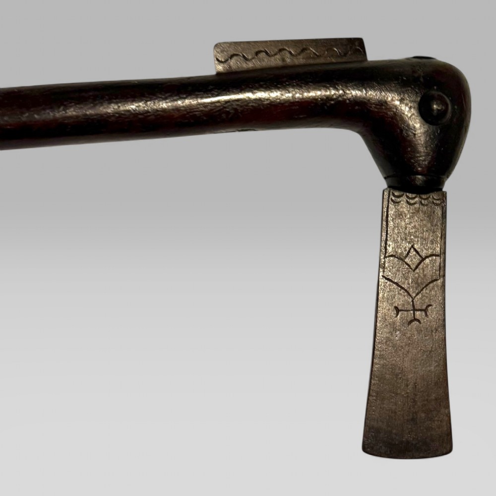 A 19th-century Dahomey messenger recade axe featuring an angled hardwood shaft and a flat iron blade. View VI