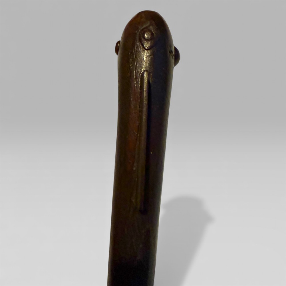 A 19th-century Dahomey messenger recade axe featuring an angled hardwood shaft and a flat iron blade. View X