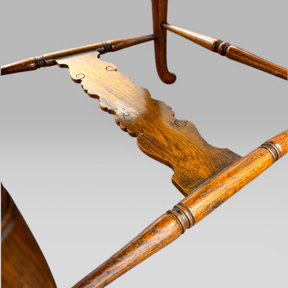 A Victorian carved golden oak armchair featuring a pierced vertical slat backrest, sculpted armrests, turned legs, and a brown leather seat. View IX