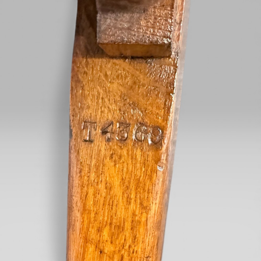 A Victorian carved golden oak armchair featuring a pierced vertical slat backrest, sculpted armrests, turned legs, and a brown leather seat. View XII