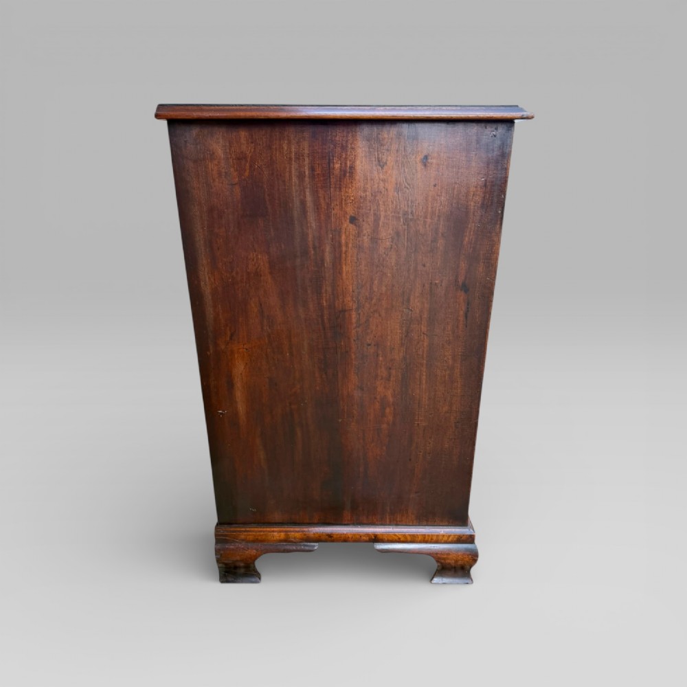 A late 18th-century George III mahogany chest of drawers featuring two short over three long drawers with brass swan-neck handles and bracket feet. View VII