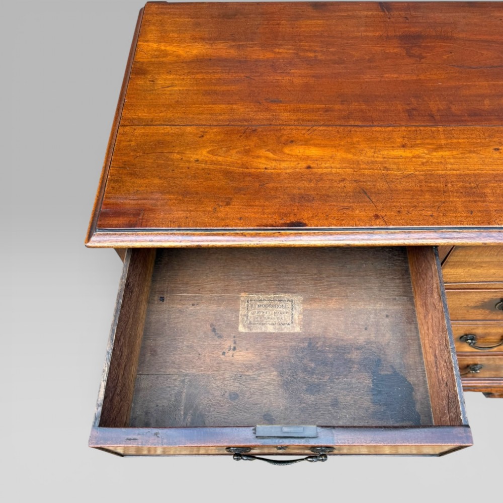 A late 18th-century George III mahogany chest of drawers featuring two short over three long drawers with brass swan-neck handles and bracket feet. View XI