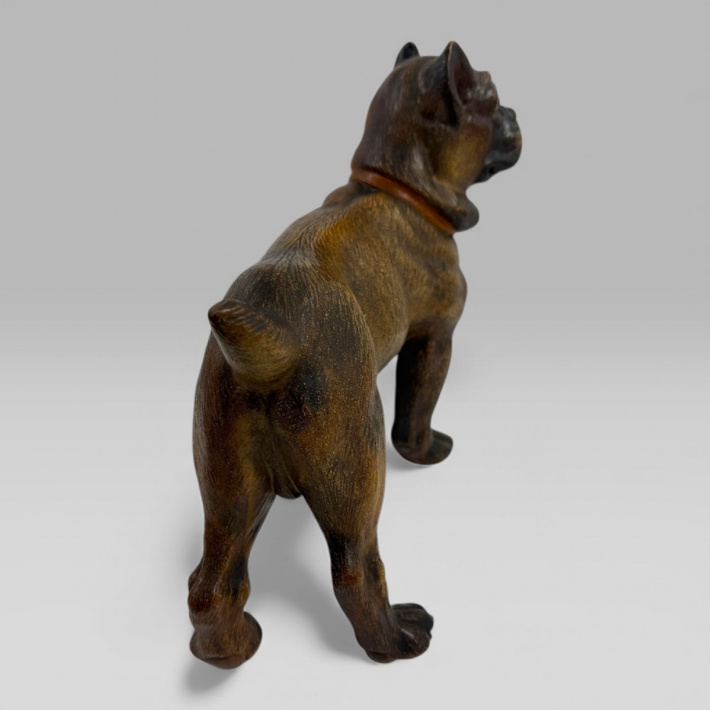 A dark brown painted terracotta dog sculpture standing upright with glass eyes and a moulded collar. View VII
