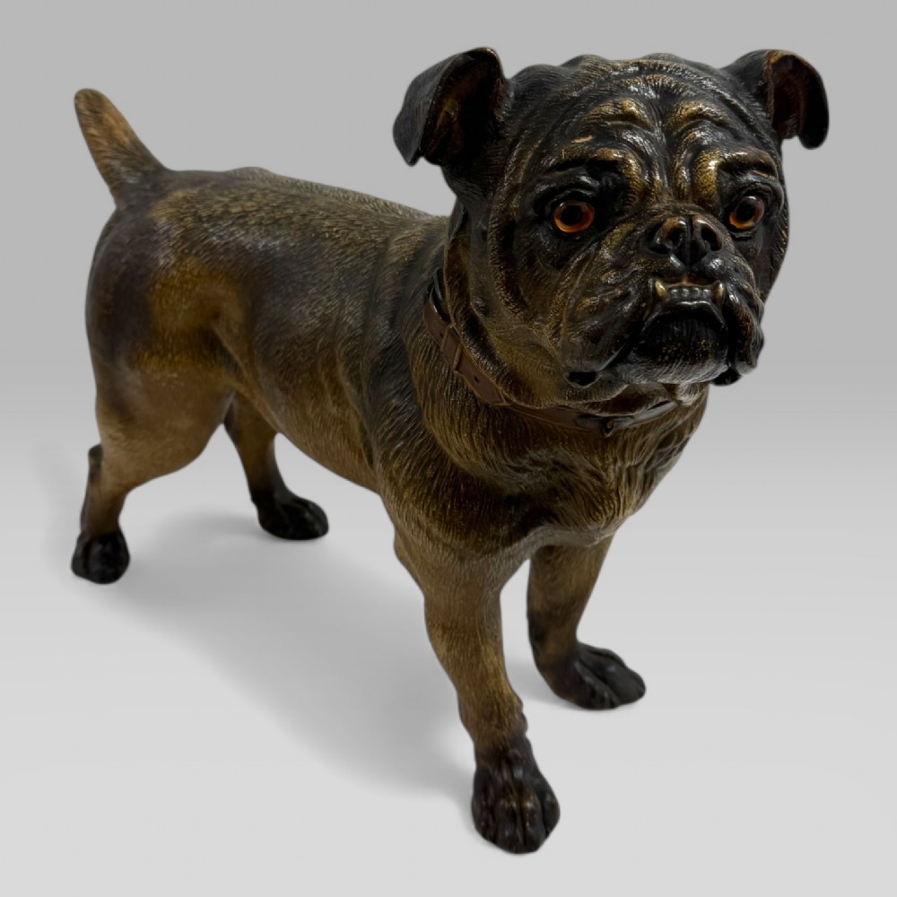 A life-size antique Austrian terracotta sculpture of a standing pug dog with inset glass eyes and a moulded collar. View II