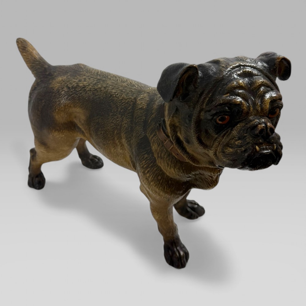 A life-size antique Austrian terracotta sculpture of a standing pug dog with inset glass eyes and a moulded collar. View IX
