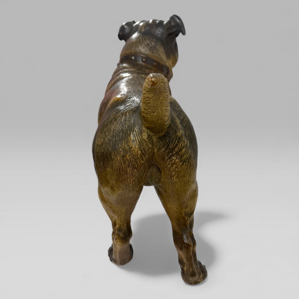 A life-size antique Austrian terracotta sculpture of a standing pug dog with inset glass eyes and a moulded collar. View X