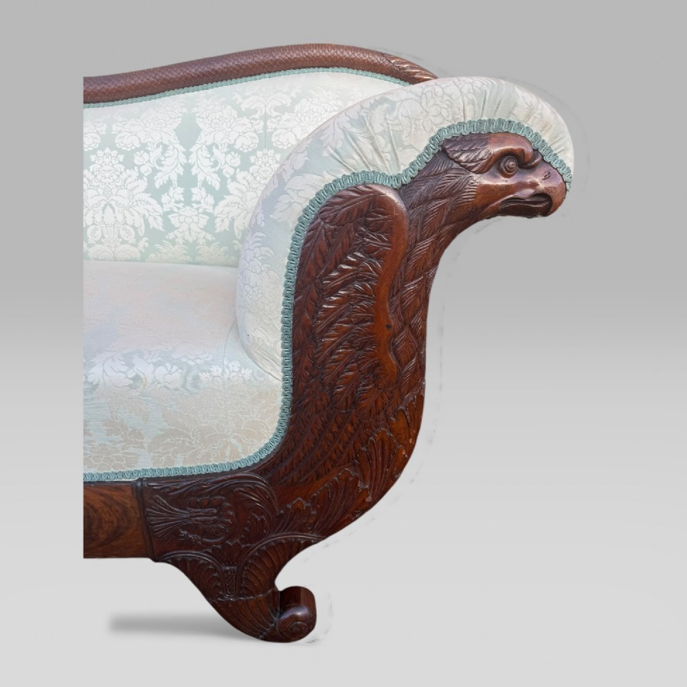 A nineteenth-century French Empire flame mahogany sofa featuring carved scroll arms, a serpentine crest, and light blue damask fabric upholstery. View VI