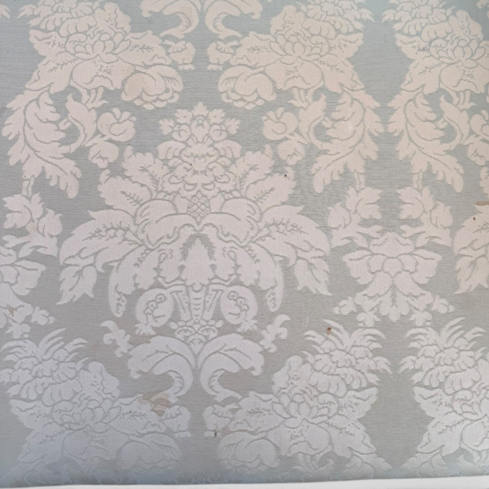 A nineteenth-century French Empire flame mahogany sofa featuring carved scroll arms, a serpentine crest, and light blue damask fabric upholstery. View XIV