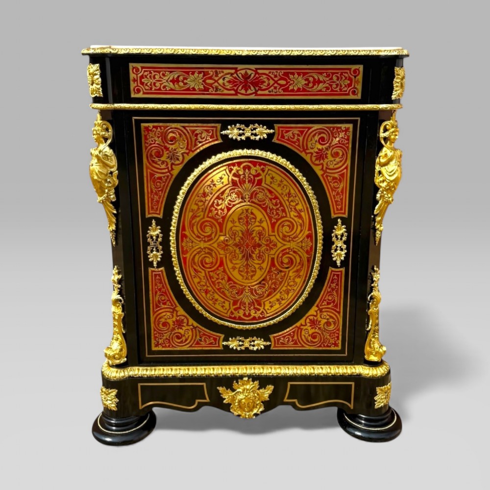 A French Napoleon III ebonised pier cabinet featuring red tortoiseshell and brass Boulle marquetry, gilt bronze mounts, and a white marble top. View II