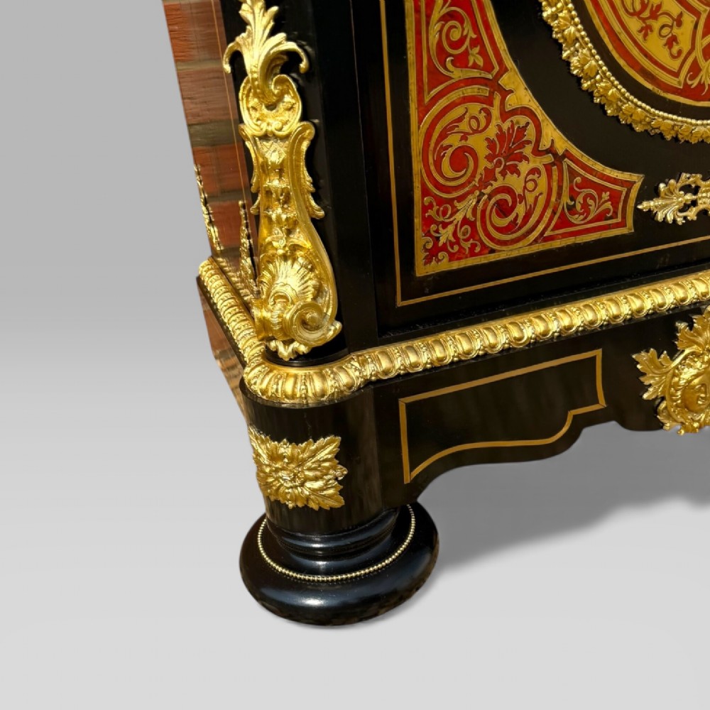A French Napoleon III ebonised pier cabinet featuring red tortoiseshell and brass Boulle marquetry, gilt bronze mounts, and a white marble top. View V