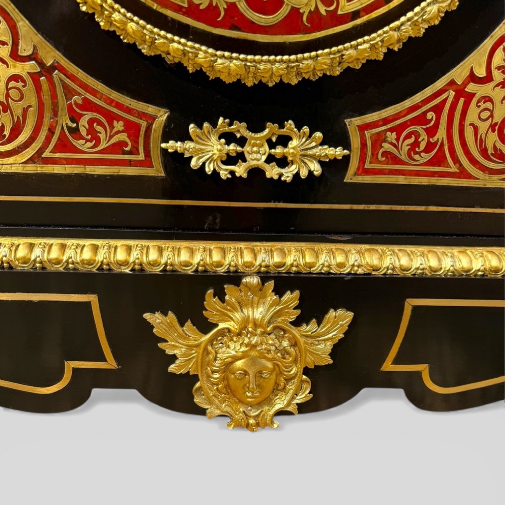 A French Napoleon III ebonised pier cabinet featuring red tortoiseshell and brass Boulle marquetry, gilt bronze mounts, and a white marble top. View VI