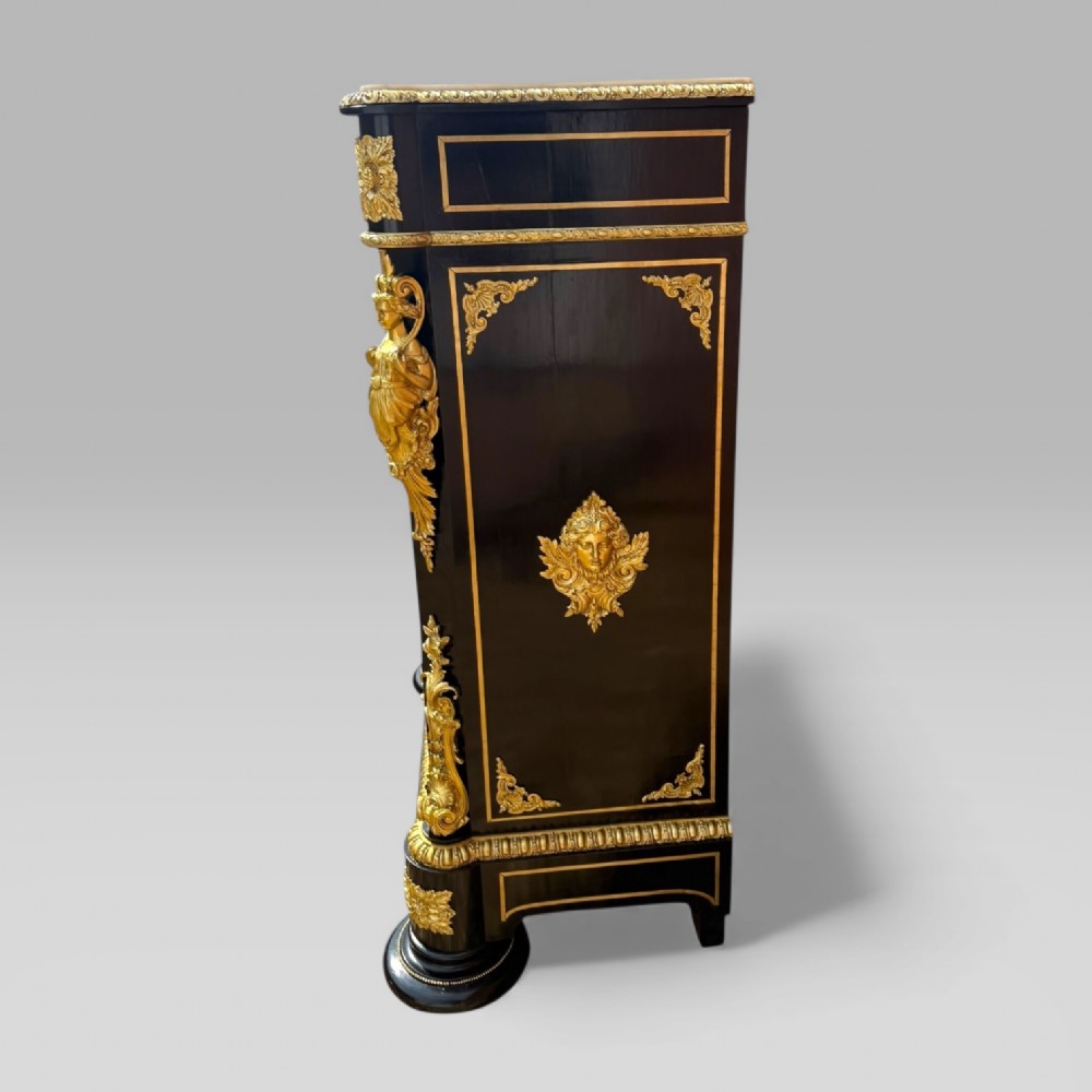 A French Napoleon III ebonised pier cabinet featuring red tortoiseshell and brass Boulle marquetry, gilt bronze mounts, and a white marble top. View IX