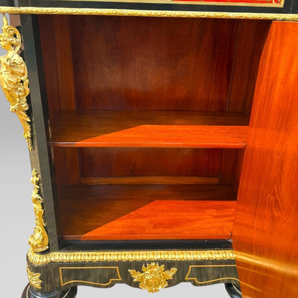 A French Napoleon III ebonised pier cabinet featuring red tortoiseshell and brass Boulle marquetry, gilt bronze mounts, and a white marble top. View XI