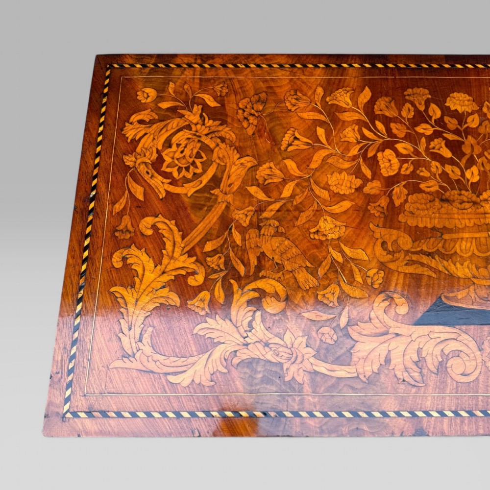 An 18th-century Dutch mahogany console table cabinet featuring detailed floral marquetry inlay, twin supporting columns, and a central cupboard door on a plinth base. View VIII