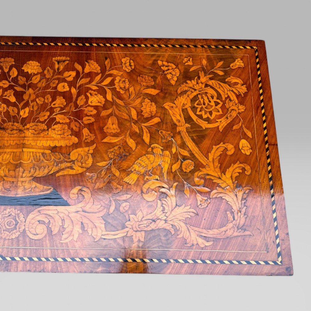 An 18th-century Dutch mahogany console table cabinet featuring detailed floral marquetry inlay, twin supporting columns, and a central cupboard door on a plinth base. View IX