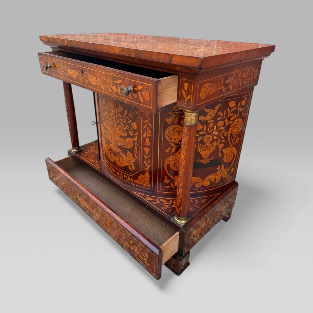 An 18th-century Dutch mahogany console table cabinet featuring detailed floral marquetry inlay, twin supporting columns, and a central cupboard door on a plinth base. View XIII