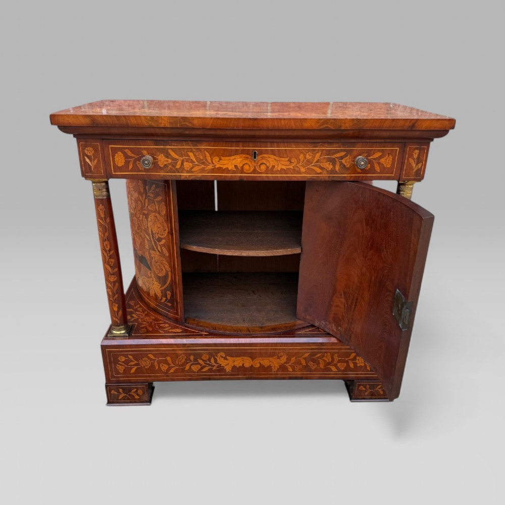 An 18th-century Dutch mahogany console table cabinet featuring detailed floral marquetry inlay, twin supporting columns, and a central cupboard door on a plinth base. View XIV