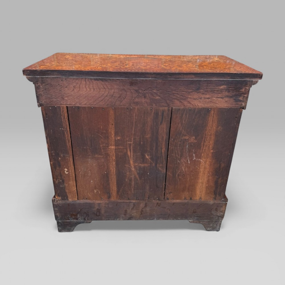 An 18th-century Dutch mahogany console table cabinet featuring detailed floral marquetry inlay, twin supporting columns, and a central cupboard door on a plinth base. View XV