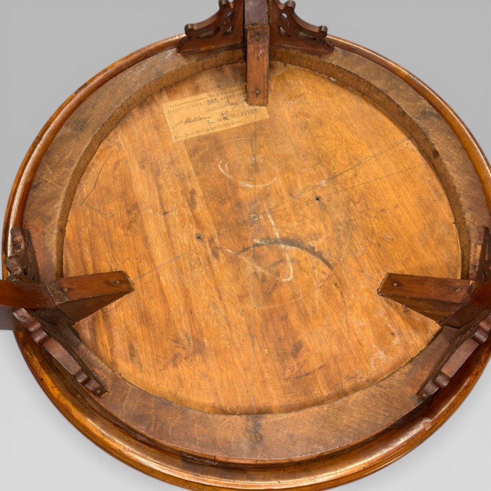 A circular antique side table featuring an intricate multi-timber geometric starburst marquetry pattern on top, set on carved cabriole legs with a triangular lower tier. View V