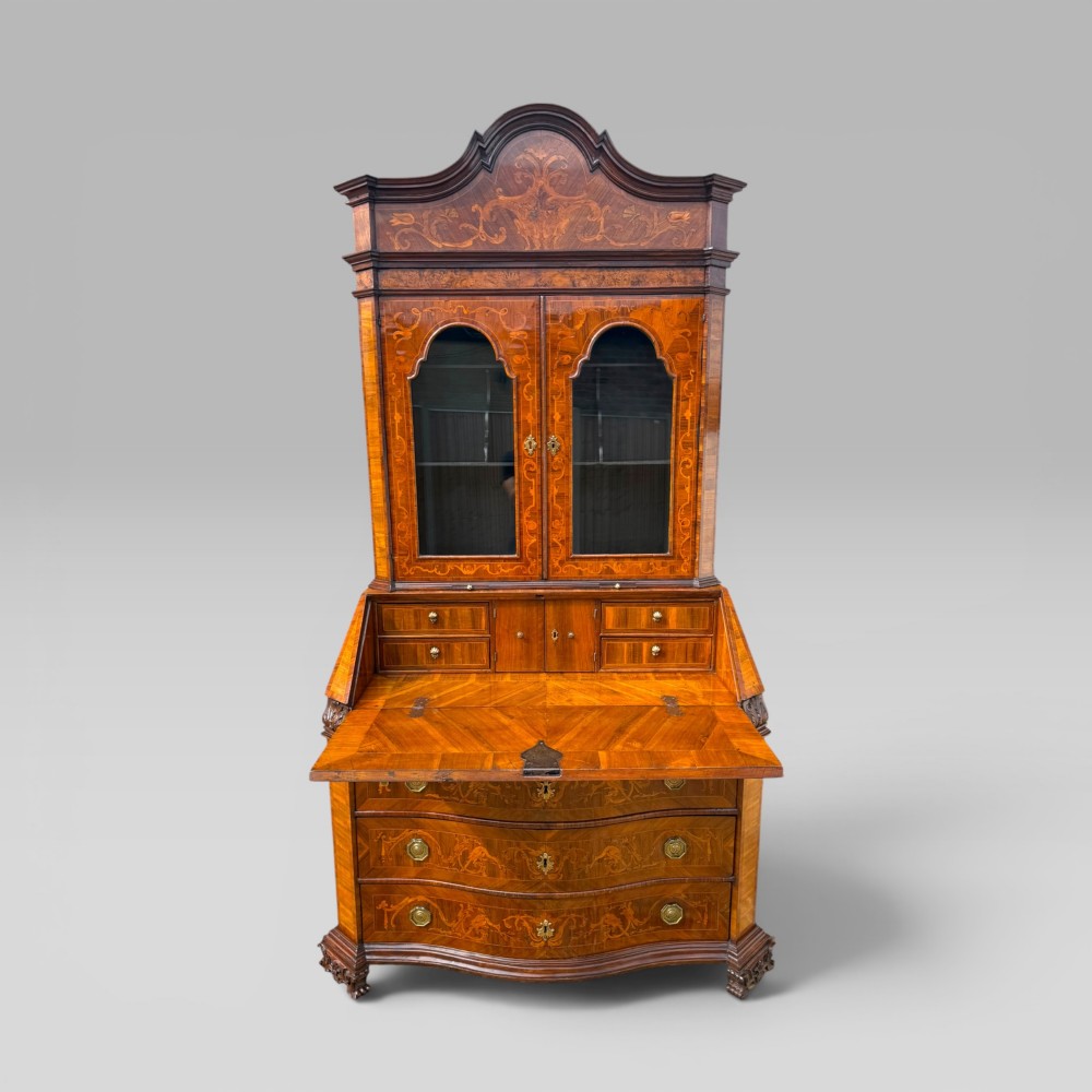 A mid-18th-century Italian Venetian bureau bookcase featuring detailed marquetry inlay, arched glazed doors, a slant-front writing desk, and three serpentine lower drawers. View II