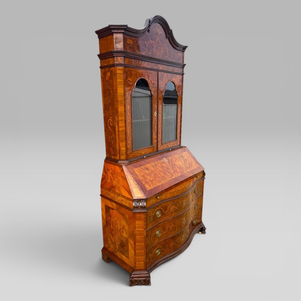 A mid-18th-century Italian Venetian bureau bookcase featuring detailed marquetry inlay, arched glazed doors, a slant-front writing desk, and three serpentine lower drawers. View V