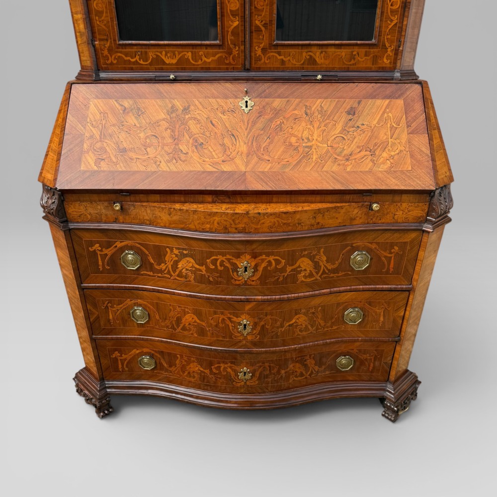 A mid-18th-century Italian Venetian bureau bookcase featuring detailed marquetry inlay, arched glazed doors, a slant-front writing desk, and three serpentine lower drawers. View VI