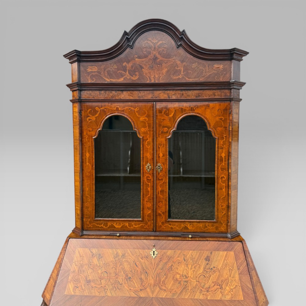 A mid-18th-century Italian Venetian bureau bookcase featuring detailed marquetry inlay, arched glazed doors, a slant-front writing desk, and three serpentine lower drawers. View VII