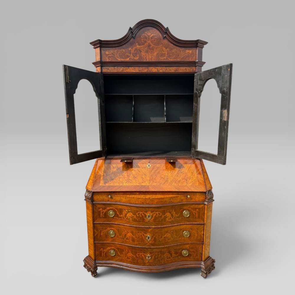 A mid-18th-century Italian Venetian bureau bookcase featuring detailed marquetry inlay, arched glazed doors, a slant-front writing desk, and three serpentine lower drawers. View X