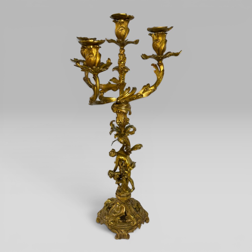 A pair of late nineteenth-century French Rococo gilt bronze candelabra with figural stems, scrolling floral arms, and ornate bases. View III