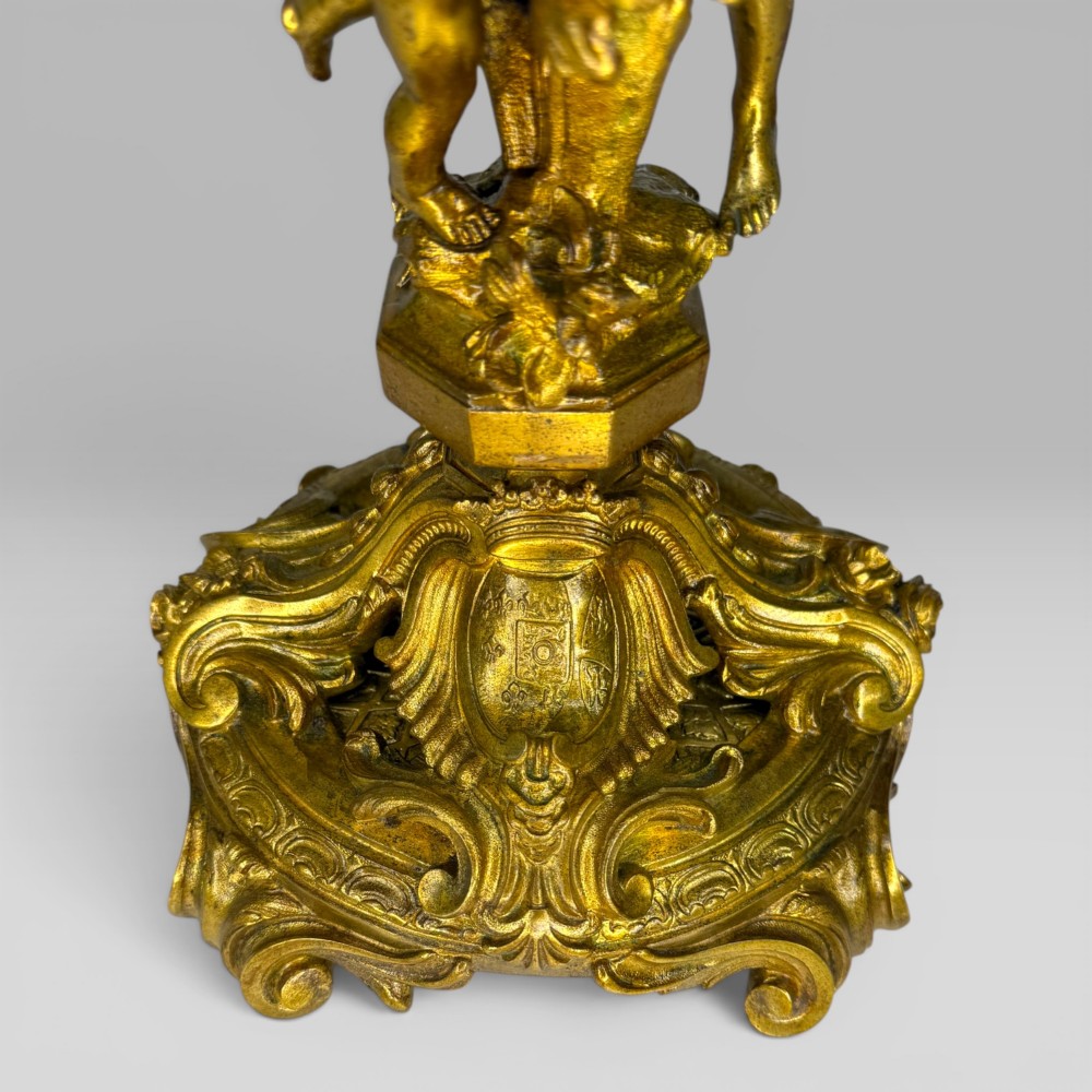 A pair of late nineteenth-century French Rococo gilt bronze candelabra with figural stems, scrolling floral arms, and ornate bases. View XII