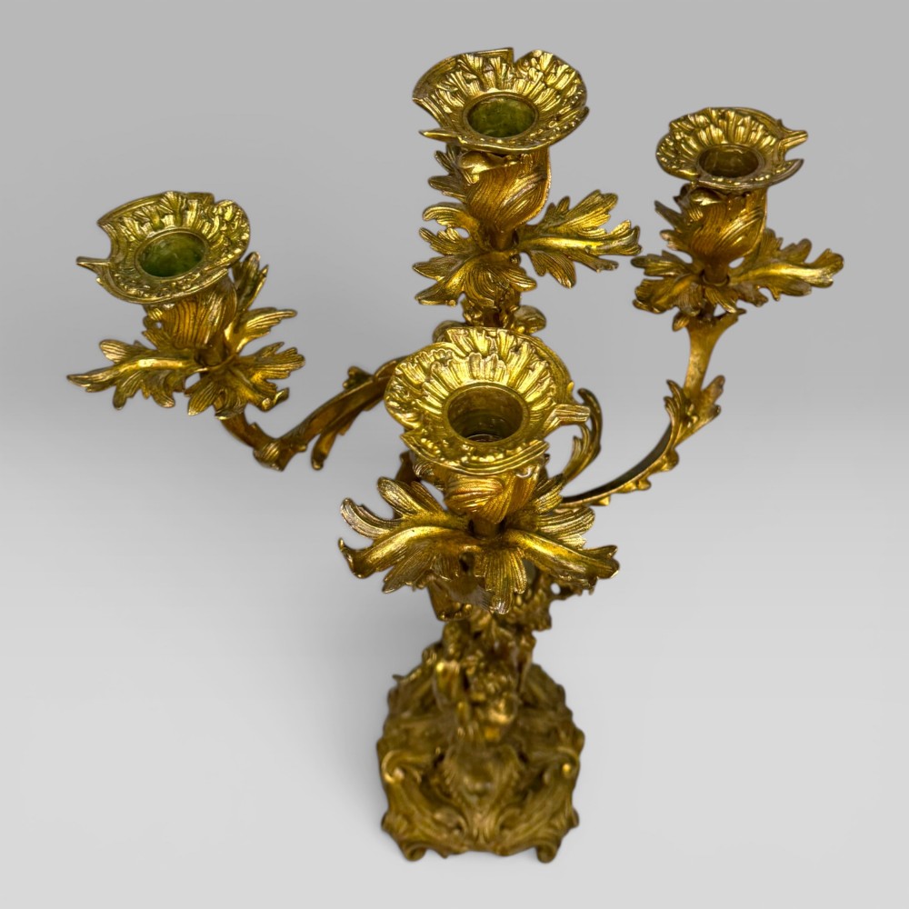 A pair of late nineteenth-century French Rococo gilt bronze candelabra with figural stems, scrolling floral arms, and ornate bases. View XIII