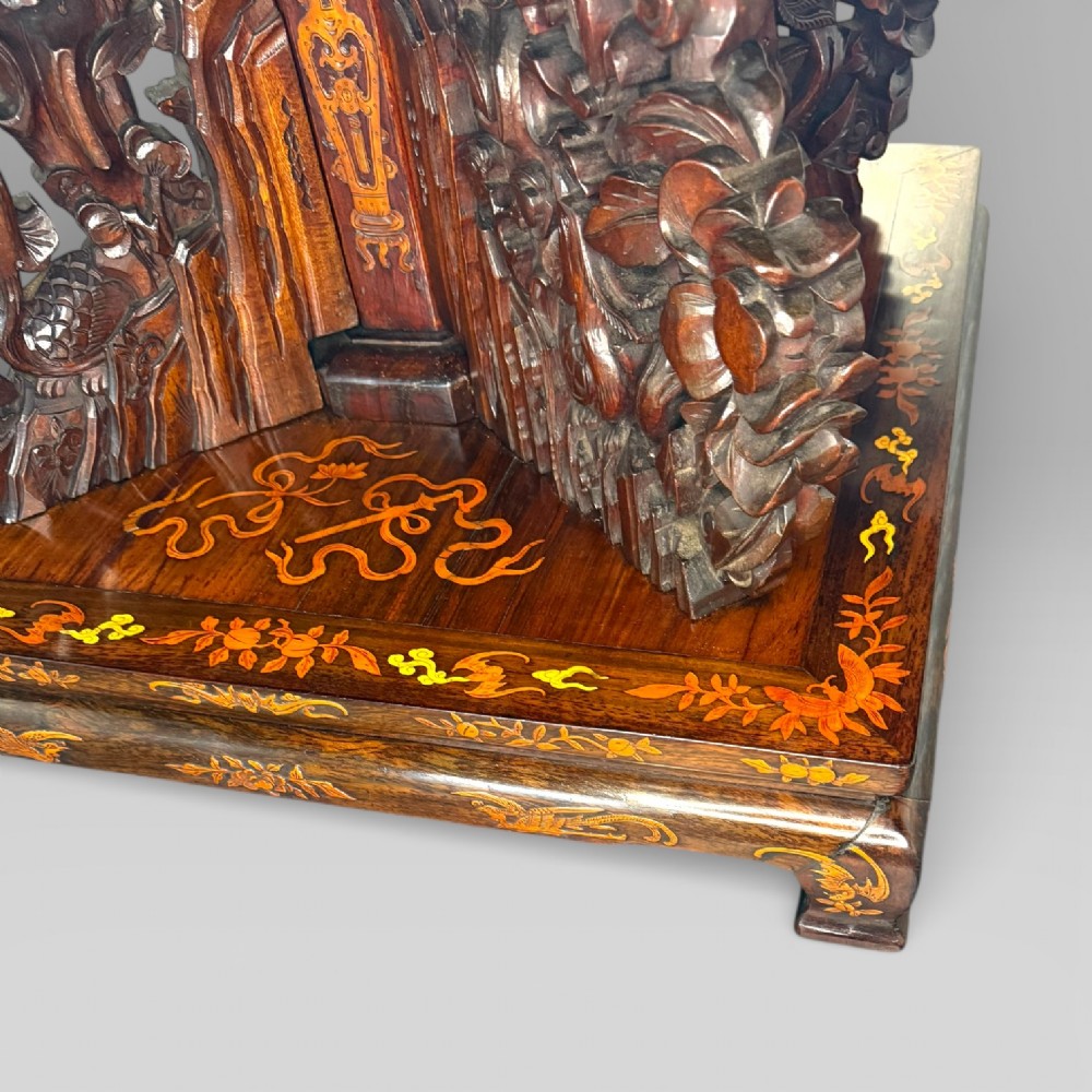 Circular rosewood centre table featuring detailed marquetry depictions of ships, pagodas, and floral motifs resting on a square inlaid pedestal base. View XV