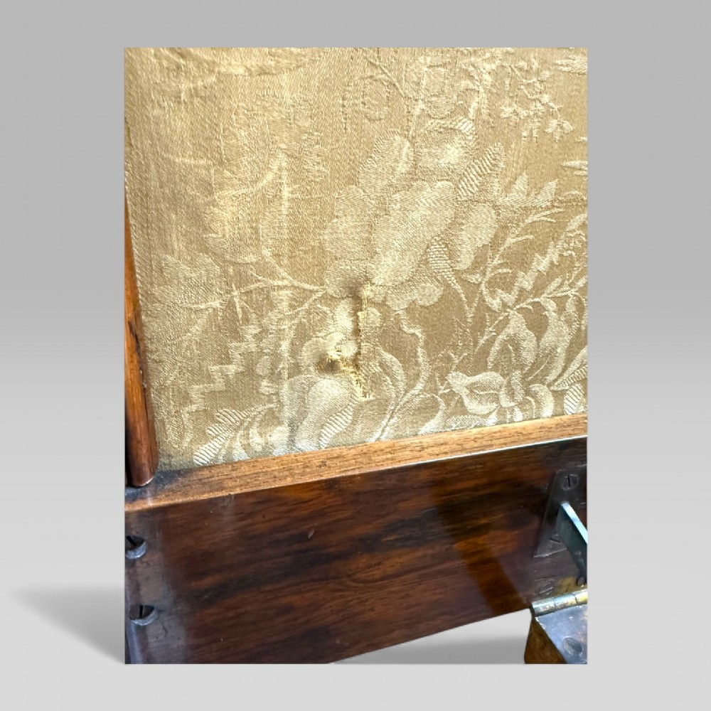 A William IV rosewood tilt-top tripod table featuring a shaped, carved frame housing a glazed needlepoint panel above a carved column and splayed tripod legs. View XIV