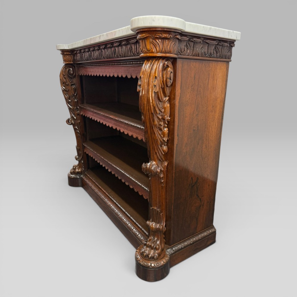 A 19th-century William IV rosewood open bookcase featuring a white marble top, intricately carved acanthus leaf side trusses, and lions paw feet. View IX