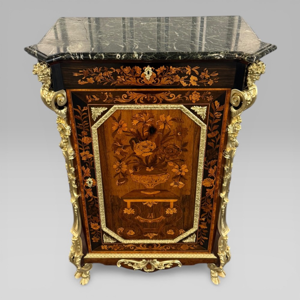 A nineteenth-century dark wood pier cabinet featuring detailed floral marquetry, polished gilt-bronze mounts, classical mask figures, and a black marble top. View III