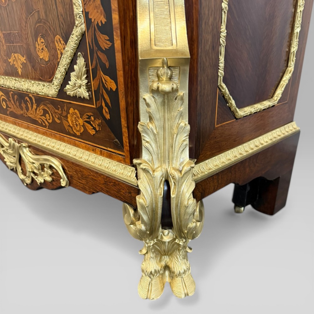 A nineteenth-century dark wood pier cabinet featuring detailed floral marquetry, polished gilt-bronze mounts, classical mask figures, and a black marble top. View IX