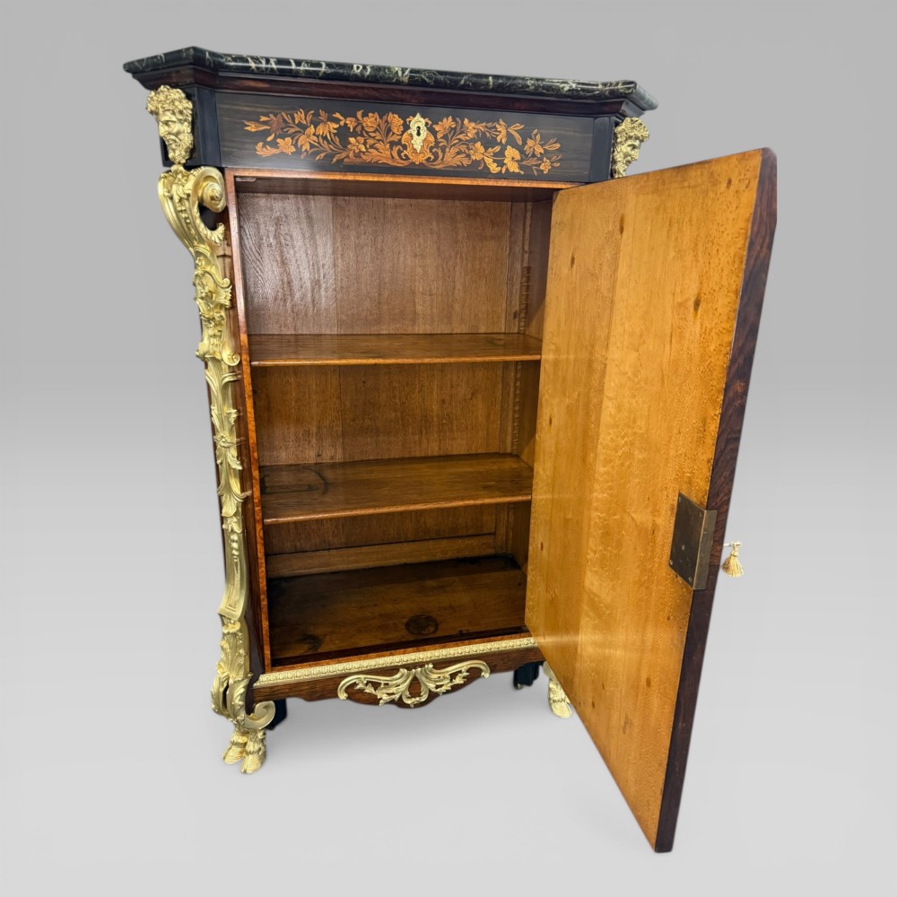 A nineteenth-century dark wood pier cabinet featuring detailed floral marquetry, polished gilt-bronze mounts, classical mask figures, and a black marble top. View XI