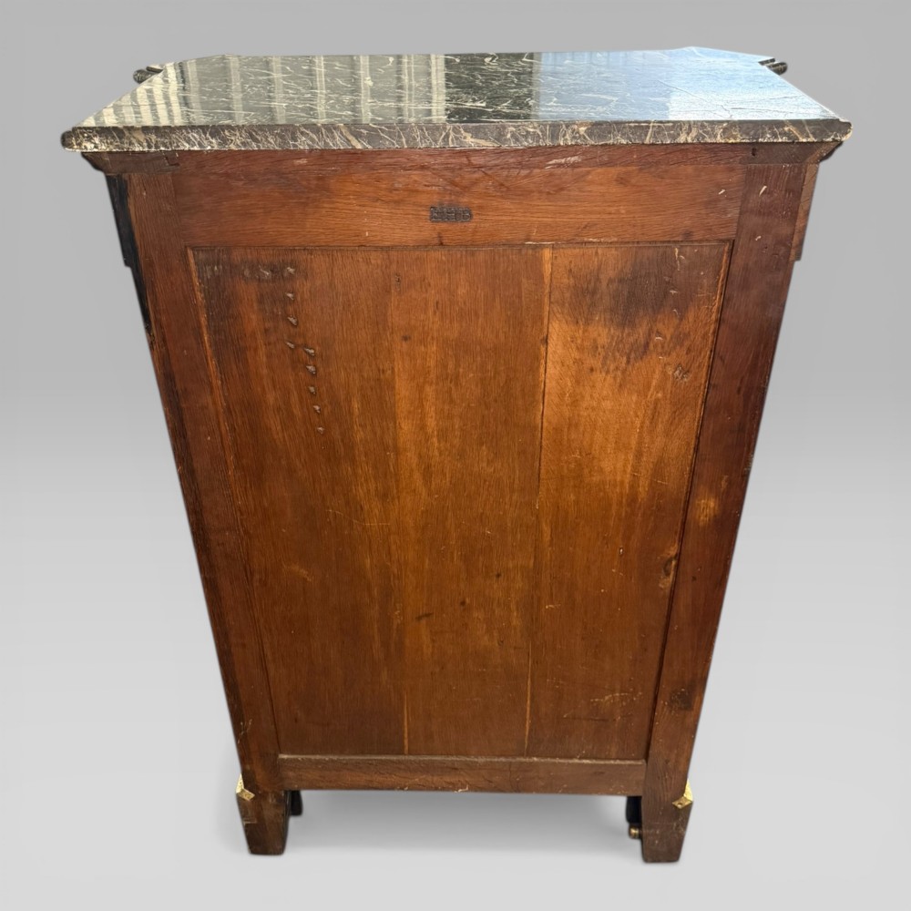 A nineteenth-century dark wood pier cabinet featuring detailed floral marquetry, polished gilt-bronze mounts, classical mask figures, and a black marble top. View XIII