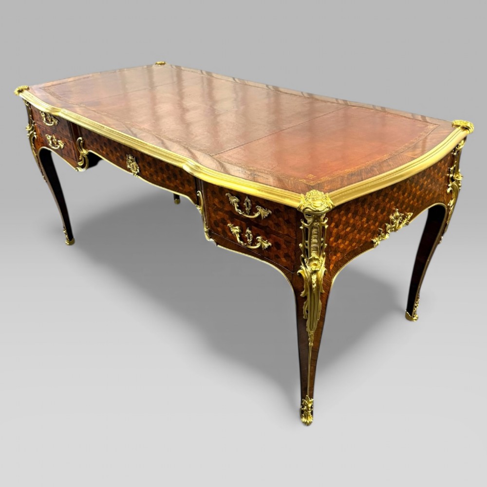 A late nineteenth-century French kingwood bureau plat featuring parquetry veneers, gilt bronze ormolu mounts, cabriole legs, and a brown leather inset writing surface. View III