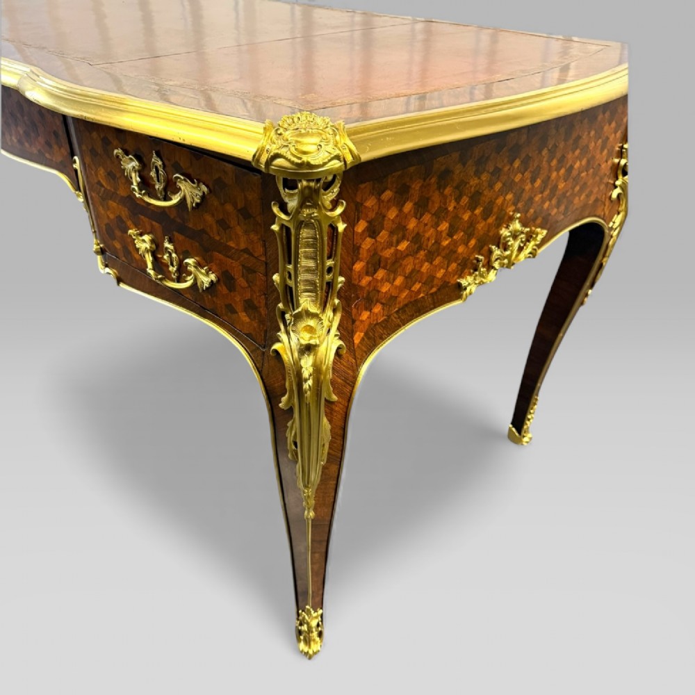 A late nineteenth-century French kingwood bureau plat featuring parquetry veneers, gilt bronze ormolu mounts, cabriole legs, and a brown leather inset writing surface. View XII
