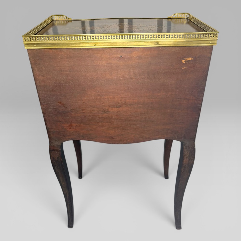A French Louis XV style kingwood petite commode featuring three floral marquetry drawers, cabriole legs, and a brass gallery top. View VIII