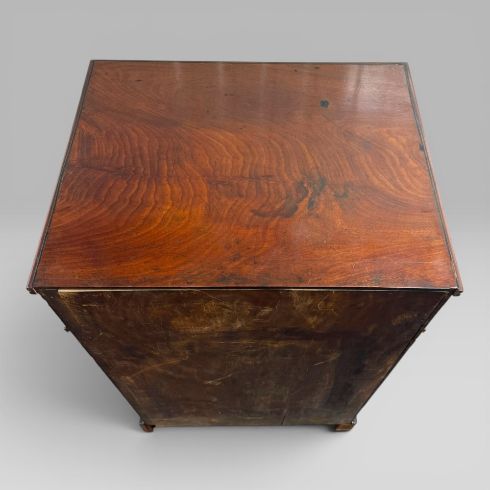 A Regency mahogany cellarette cabinet featuring reeded corner columns, a panelled door, and a flat top surface. View IX