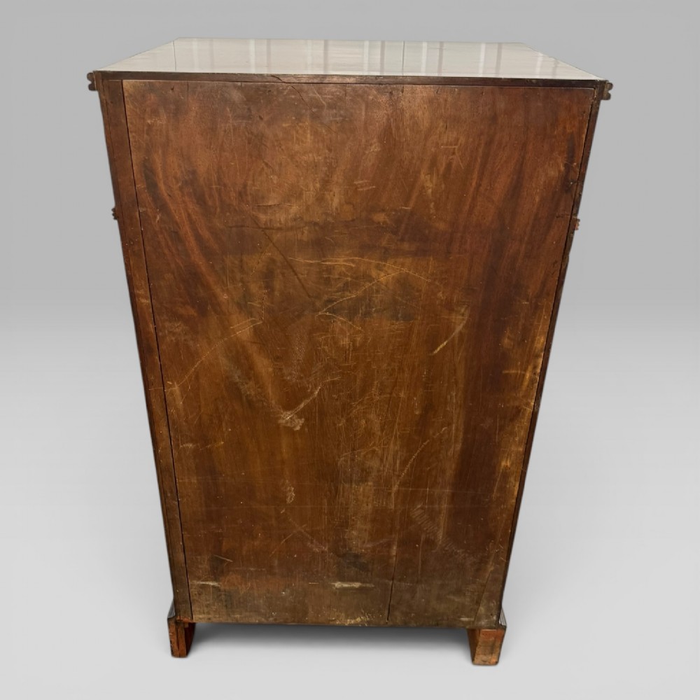 A Regency mahogany cellarette cabinet featuring reeded corner columns, a panelled door, and a flat top surface. View XI