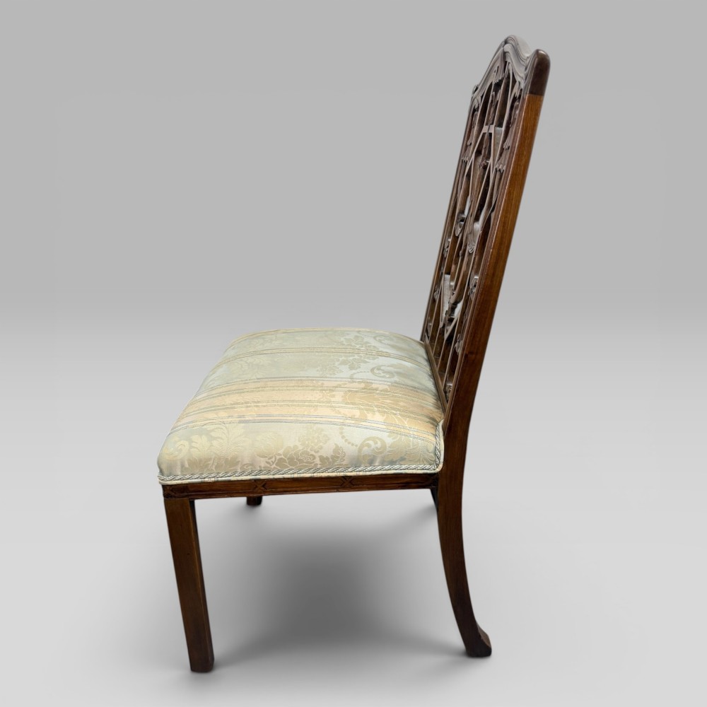 A Georgian Chippendale style dark walnut side chair with carved lattice fretwork on the backrest and a pale blue and gold striped damask seat. View V