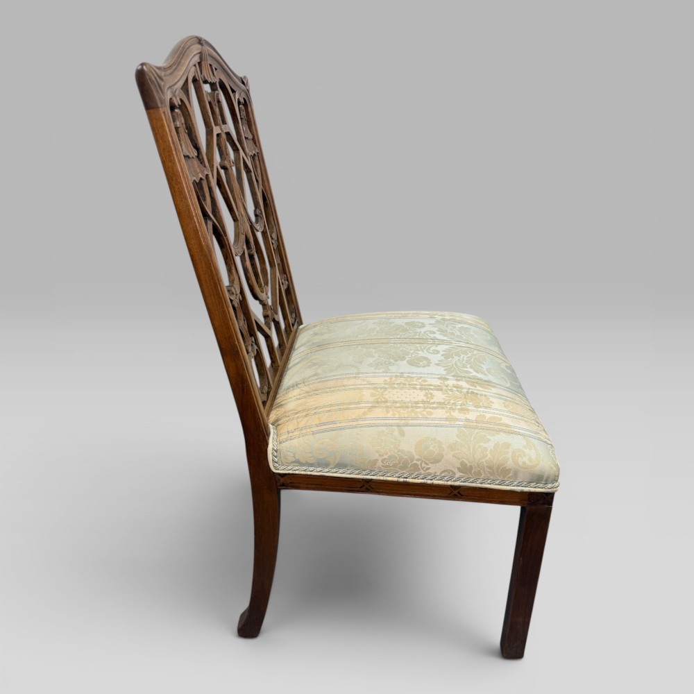 A Georgian Chippendale style dark walnut side chair with carved lattice fretwork on the backrest and a pale blue and gold striped damask seat. View VI