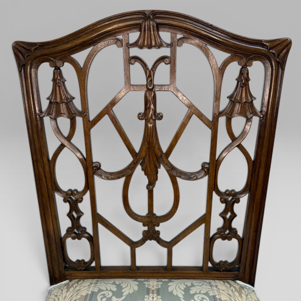 A Georgian Chippendale style dark walnut side chair with carved lattice fretwork on the backrest and a pale blue and gold striped damask seat. View VII